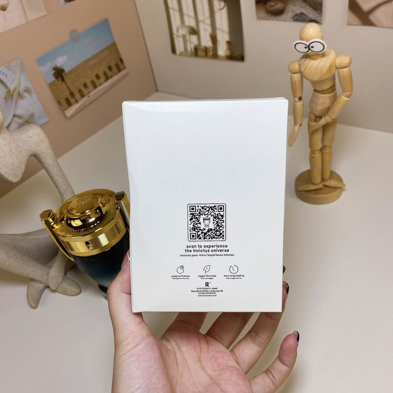 Rabanne Invictus Parfum bottle and box lifestyle display on white desk